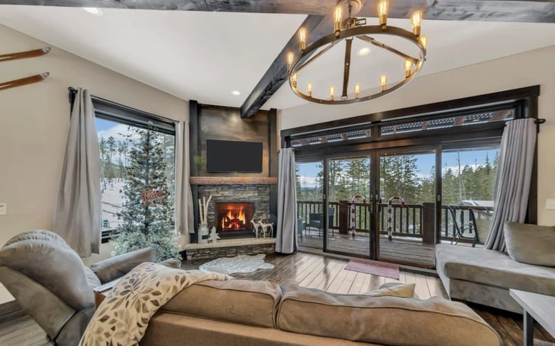 Dakota Sunset Lodge, living room with stone fireplace and forest views